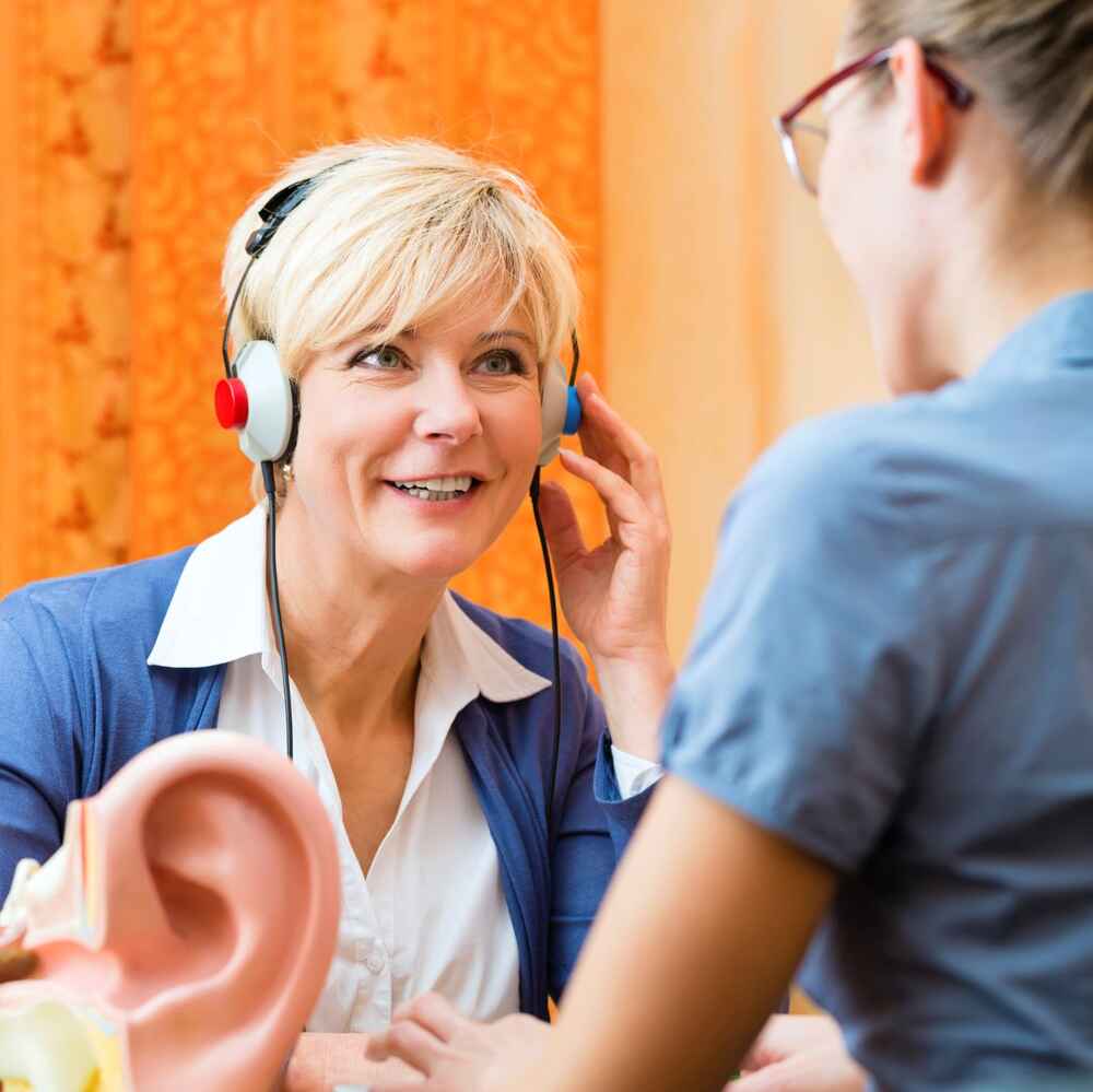 Audiologist conducting a hearing test with a patient
