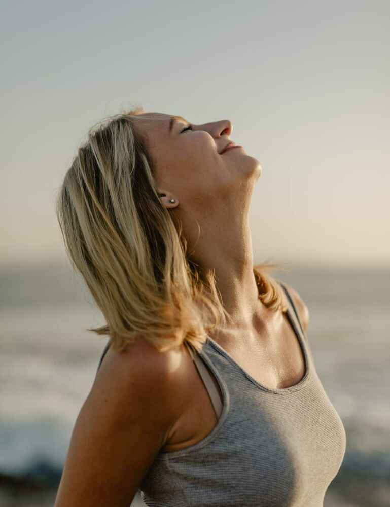 Woman happy and breathing easier at a beach