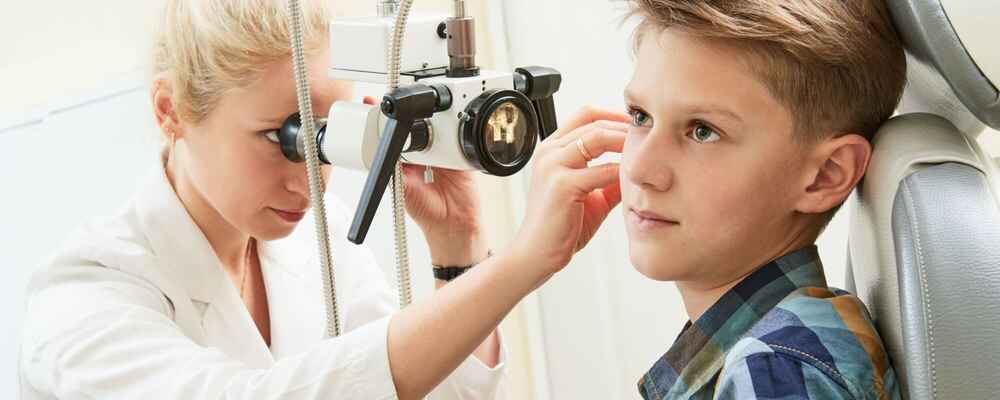 ENT doctor examining patient's ear